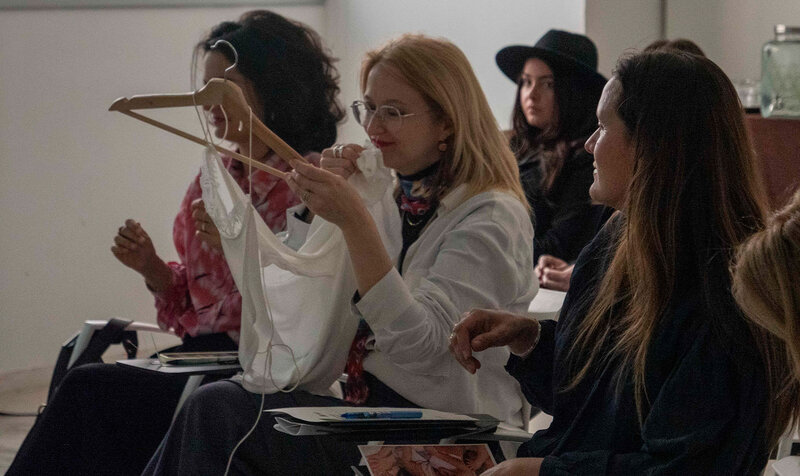 A group of people smelling a perfume created by students from IED Barcelona.