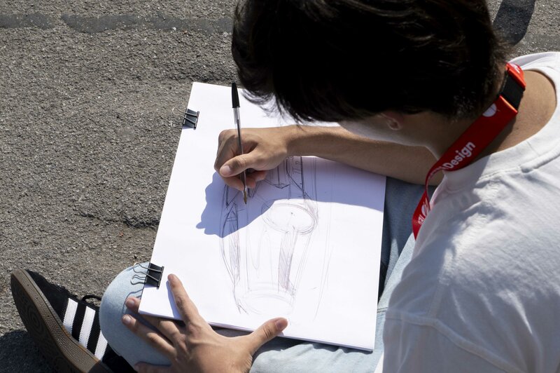 Close-up of a transportation sketch with a boy drawing a car