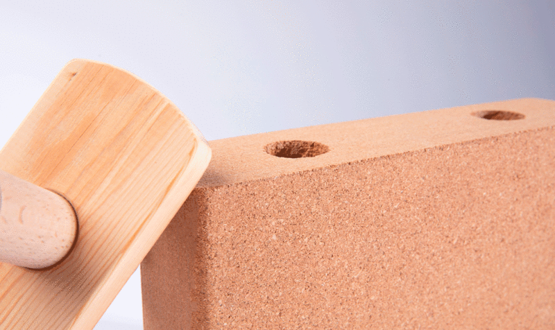 Detail of a snap-together cork panel with two holes and the fixing system