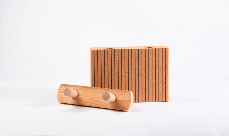 A cork snap-together panel next to the wooden fixing system on a white background