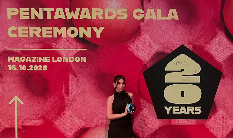 Young woman showing off her award at the event's photocall