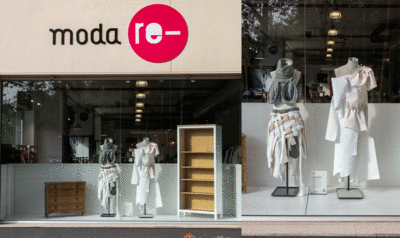 Two mannequins in front of a Moda Re-store window.