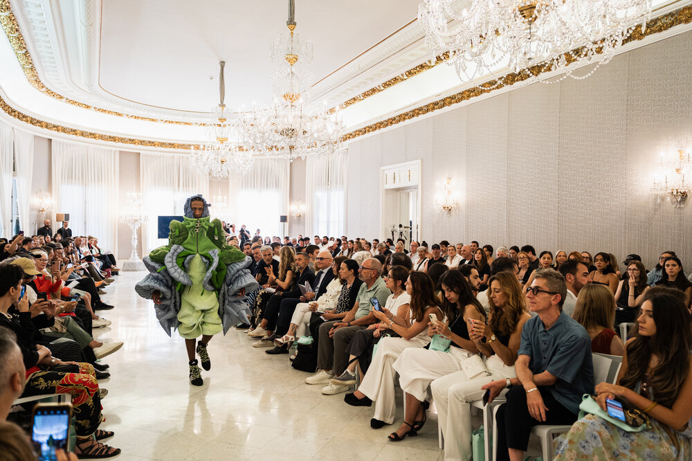 A model parading in a room of the Palau Reial de Pedralbes