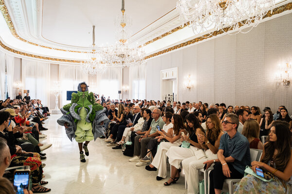 A model parading in a room of the Palau Reial de Pedralbes