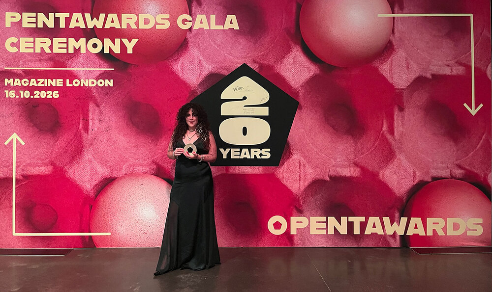 Young woman showing off her award at the event's photocall