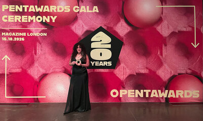 Young woman showing off her award at the event's photocall