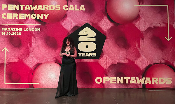 Young woman showing off her award at the event's photocall