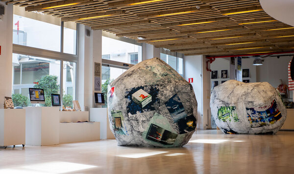 Art and design exhibition featuring two central rocks sewn with printed fabrics