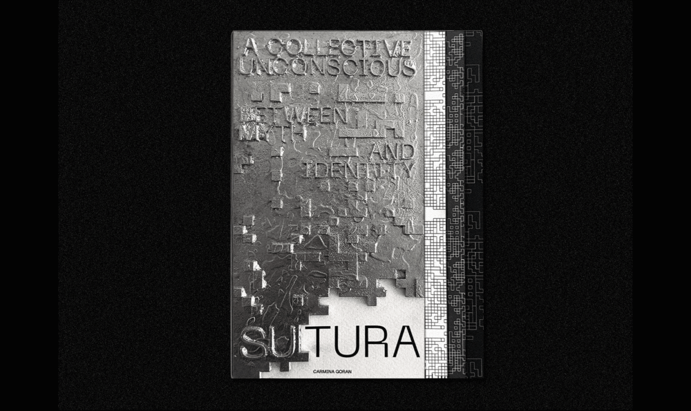 A metal book with embossed letters on a black background