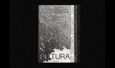 A metal book with embossed letters on a black background