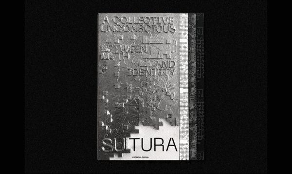 A metal book with embossed letters on a black background