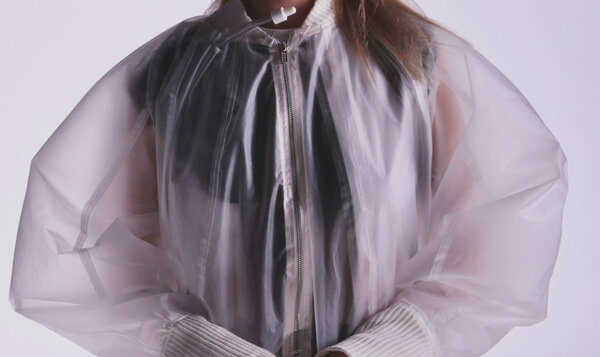 Close-up of a transparent jacket that stores water and features a drinking tube like a straw.