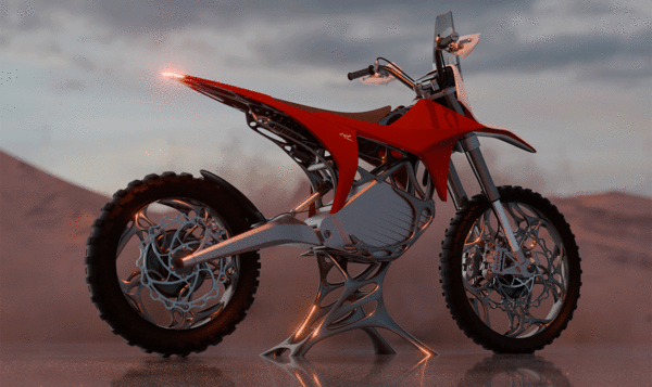 Red and white off-road electric motorcycle in a desert landscape seen from the side