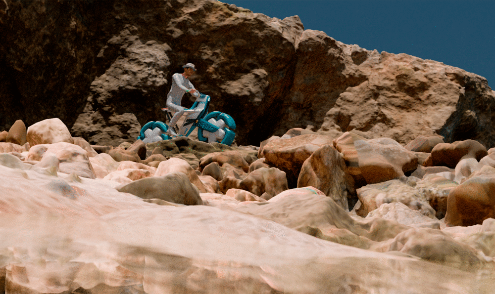 Motorcyclist on an amphibious motorcycle in a beach and rocky landscape