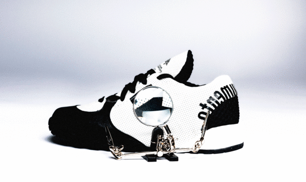 A sports shoe seen from the side with black and white motifs
